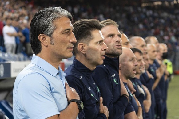 The Swiss staff with from left, head coach Murat Yakin, assistant coach Vincent Cavin, and goalkeeper coach Patrick Foletti sing the national anthem of Switzerland, ahead of the 2022 FIFA World Cup Eu ...