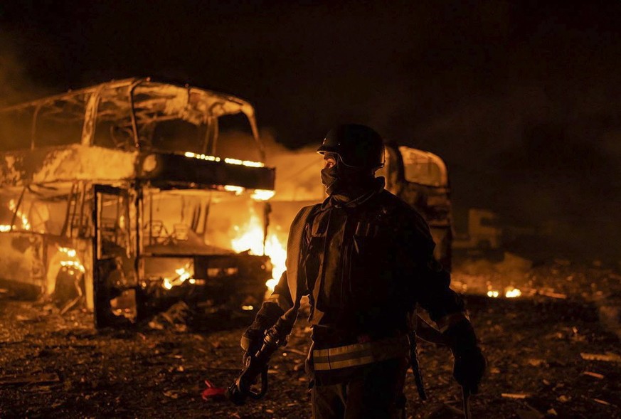 epa10630681 A handout photo released by the press service of the State Emergency Service (SES) of Ukraine shows rescuers putting out a fire following a rocket attack, in Kyiv (Kiev), Ukraine, 16 May 2 ...