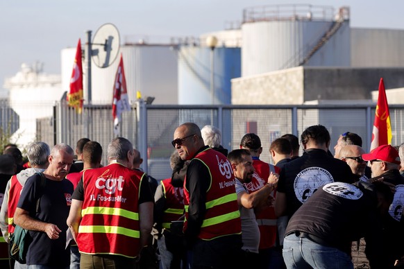 epa10235617 Workers from TotalEnergies and Esso ExxonMobil attend a protest called by CGT union outside Esso refinery in Fos-Sur-Mer, France, 11 October 2022. The two weeks strike at refineries affect ...