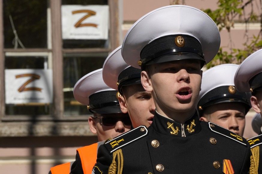 Navy school cadets attend celebrations marking 318th anniversary of the city of Kronstadt, outside St. Petersburg, Russia, Saturday, May 21, 2022, with sheets depicting letter Z, which has become a sy ...