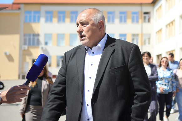 Former Prime Minister Boyko Borissov speaks to journalists after casting his vote in a polling station in Bankya, Bulgaria, Sunday, April 19, 2026, during early parliamentary elections. (AP Photo/Vale ...