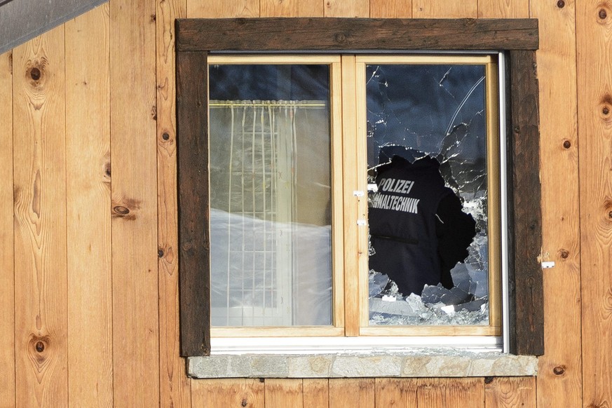 Police investigate traces of gun shots on the wall and on a broken windows on the neighbour house of the gunman in the scene after a shooting in the street of Daillon, Switzerland, Friday, January 4,  ...
