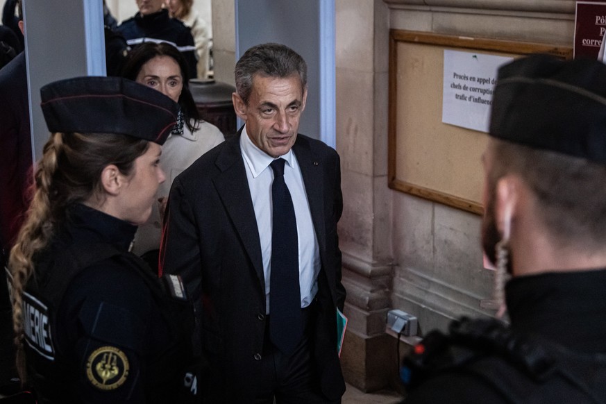epa10349672 Former French president Nicolas Sarkozy (C) arrives at the court for an appeal trial for corruption and influence peddling in Paris, France, 05 December 2022. Former French president Sarko ...
