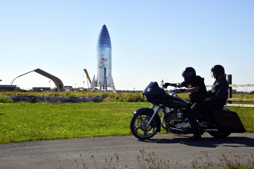 FILE - In this Jan. 12, 2019 file photo, a motorcyclist rides near the SpaceX prototype Starship hopper at the Boca Chica Beach site in Texas. SpaceX says it will build its Mars spaceship in south Tex ...