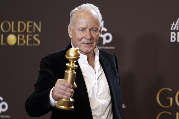 epa12643933 Swedish actor Stellan Skarsgard poses in the press room with the award for best performance by a male actor in a supporting role in any motion picture for 'Sentimental Value' dur ...
