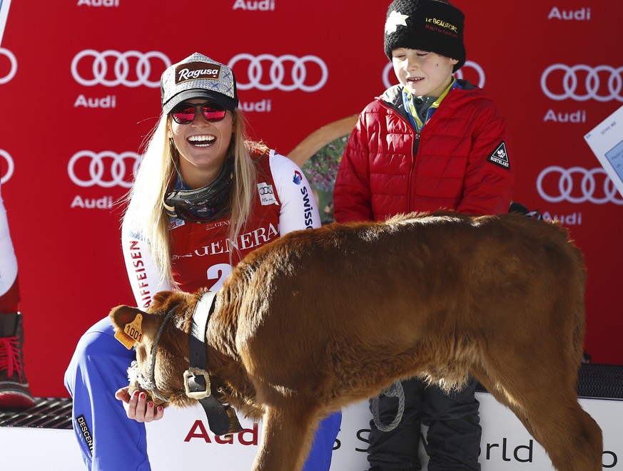 Switzerland&amp;#039;s Lara Gut smiles as she poses next to a calf after winning an alpine ski, women&amp;#039;s World Cup downhill, in Val D&amp;#039;Isere, France, Saturday, Dec. 19, 2015. (AP Photo ...