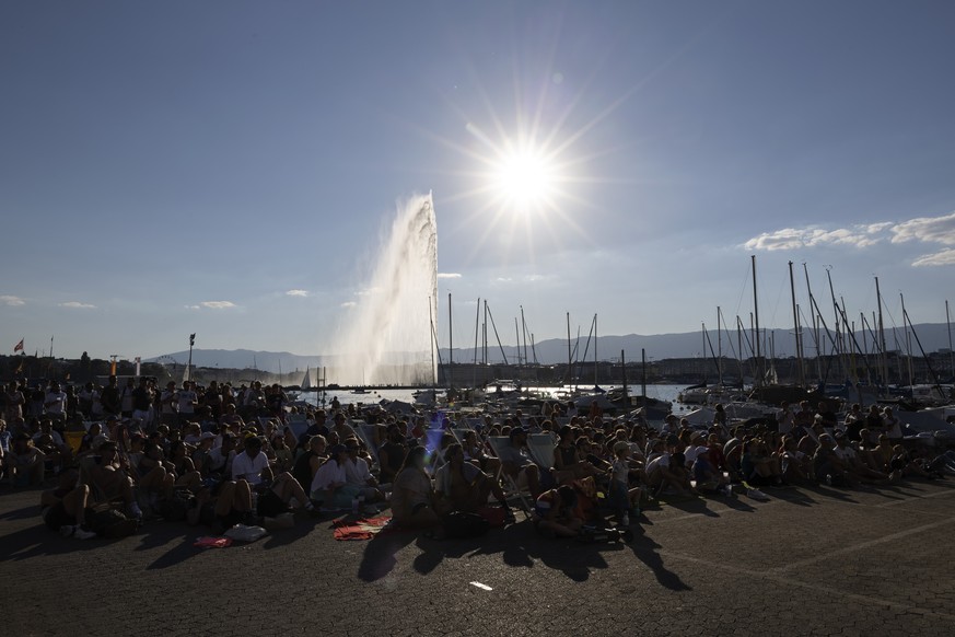 People watch the match on a giant screen on the bank of the Geneva Lake, during the live broadcast of the UEFA Women's England 2022 Final between England and Germany, in Geneva, Switzerland, Sund ...