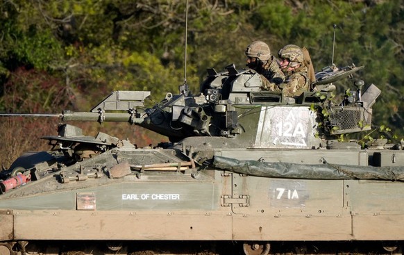 SALISBURY, ENGLAND - NOVEMBER 23: Prince William, Prince of Wales, Colonel-in-Chief, 1st Battalion Mercian Regiment (L) listens to a briefing ahead of an attack exercise during a visit to the regiment ...