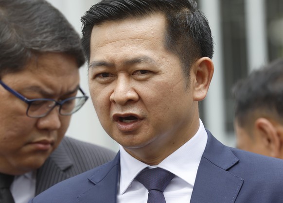 epa12172860 Former Thai Prime Minister Thaksin Shinawatra&#039;s lawyer Winyat Chatmontree (R) talks to the media on Thaksin&#039;s case, outside the Thai Supreme Court���s Criminal Case Division for  ...