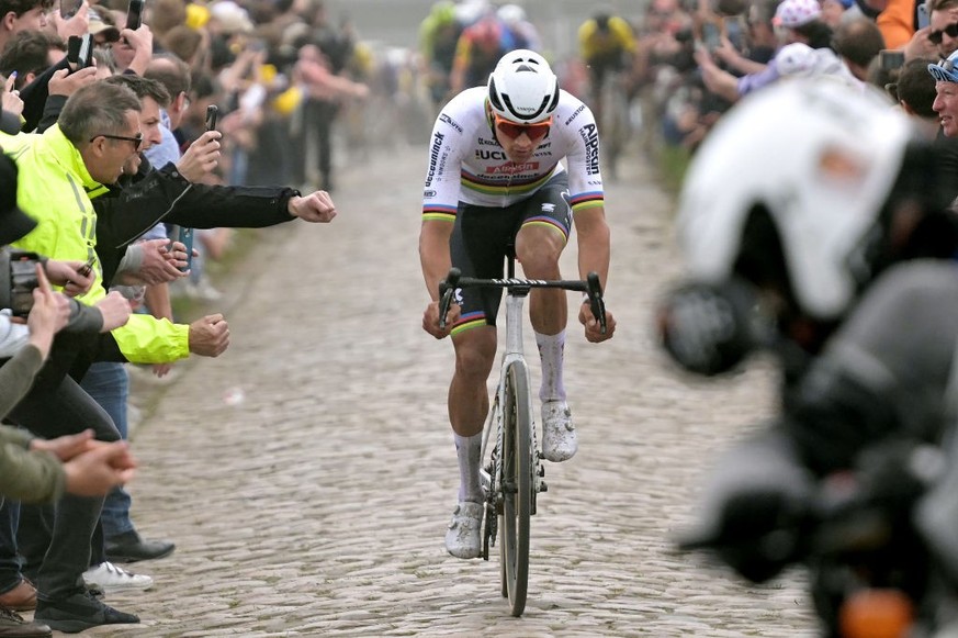 ROUBAIX, FRANCE - APRIL 07: Mathieu van der Poel of The Netherlands and Team Alpecin - Deceuninck competes in the breakaway passing through the Mérignies à Avelin cobblestones sector while fans cheer  ...