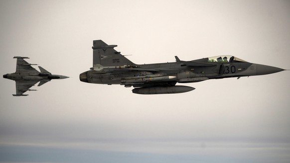 epa12521434 Two JAS-39C Gripen fighter aircrafts of the Hungarian Defense Forces (HDF) fly during an alert response simulation at the Siauliai Air Base of NATO&#039;s Baltic Air Policing (BAP) mission ...