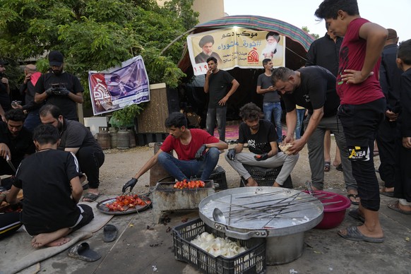 Supporters of the Shiite cleric Muqtada al-Sadr cook food outside the Iraqi Parliament during a sit-in protest in Baghdad, Iraq, Thursday, Aug. 25, 2022. (AP Photo/Hadi Mizban)
