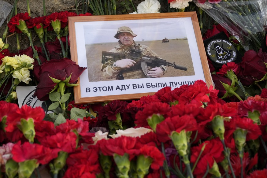 An image of the owner of private military company Wagner Group, Yevgeny Prigozhin, with words in Russian &#039;In this hell you were the best&#039; lies at an informal memorial next to the former &#03 ...