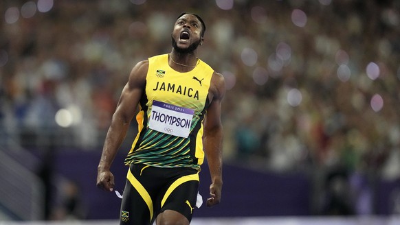 Kishane Thompson, of Jamaica, reacts after crossing the finish line in the men&#039;s 100 meters final at the 2024 Summer Olympics, Sunday, Aug. 4, 2024, in Saint-Denis, France. Noah Lyles, of the Uni ...
