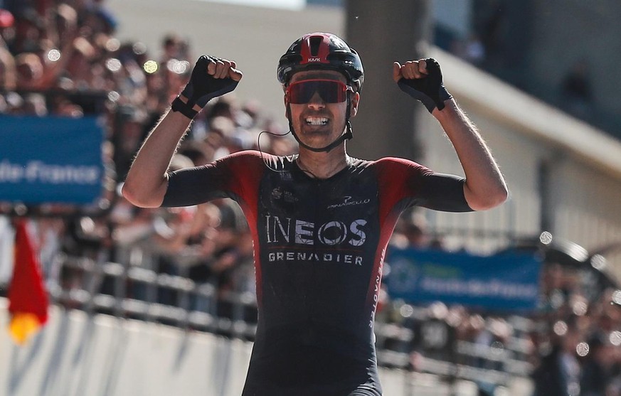 epa09894672 Ineos Grenadiers team rider Dylan Van Baarle of the Netherlands cycles past the finish line to win the Paris - Roubaix cycling race in Compiegne, France, 17 April 2022. EPA/CHRISTOPHE PETI ...