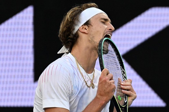 epa09699149 Alexander Zverev of Germany reacts while in action against Radu Albot of Moldova in their third round match of the Australian Open Tennis Tournament at Melbourne Park in Melbourne, Austral ...