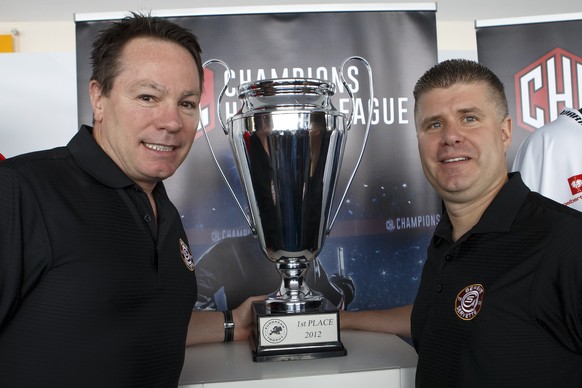 Chris McSorley, Manager and head coach of Swiss club HC Geneve-Servette, poses with Louis Matte of Swiss club HC Geneve-Servette, next to the Champions Hockey League trophy after the drawing of the ga ...