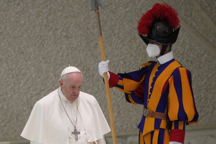 Pope Francis arrives to attend his weekly general audience in the Paul VI Hall at the Vatican, Wednesday, Feb. 16, 2022. The Vatican this week is hosting a three-day symposium on the Catholic priestho ...