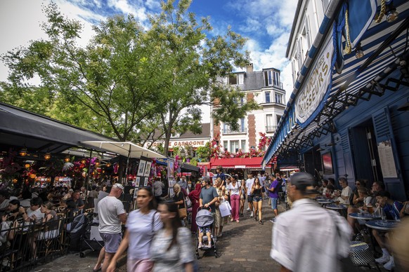Tourists stroll the Place du Tertre in the Montmartre district in Paris, France, Monday, Aug. 4, 2025. (AP Photo/Aurelien Morissard)
France Tourism Montmartre