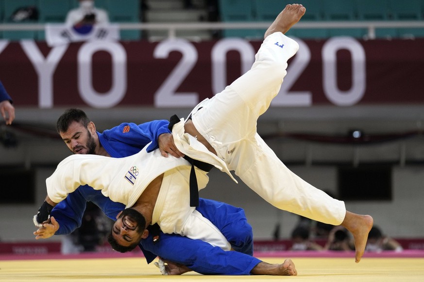 Victor Sterpu of Moldova, top, and Tohar Butbul of Israel compete during their men&#039;s -73kg round of 16 judo match at the 2020 Summer Olympics in Tokyo, Japan, Monday, July 26, 2021. (AP Photo/Vin ...
