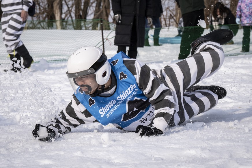A player is seen in action during the Showa-shinzan International Yukigassen snowball fight competition in Sobetsu, Hokkaido prefecture on February 21, 2026. At the foot of an active volcano in northe ...