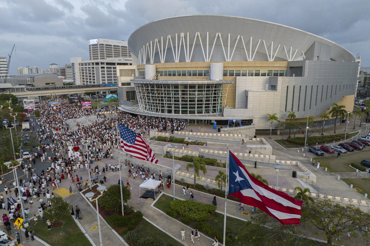 An aerial view shows people queing outside the Coliseo de Puerto Rico to attend the first show of Puerto Rican singer Bad Bunny&#039;s 30-date concert residency at the arena in San Juan, Puerto Rico,  ...