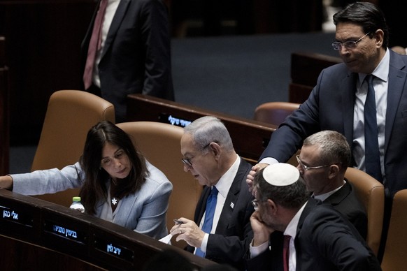 Israel&#039;s Prime Minister Benjamin Netanyahu, center, confers with lawmakers at a session of the Knesset, Israel&#039;s parliament, in Jerusalem, Monday, July 24, 2023. (AP Photo/Maya Alleruzzo)