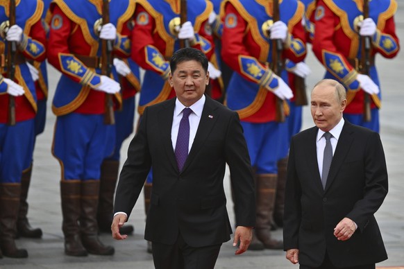FILE - Russian President Vladimir Putin, right, walks with Mongolian President Ukhnaagiin Khurelsukh, left, during a welcoming ceremony at Sukhbaatar Square in Ulaanbaatar, Mongolia, Tuesday, Sept. 3, ...