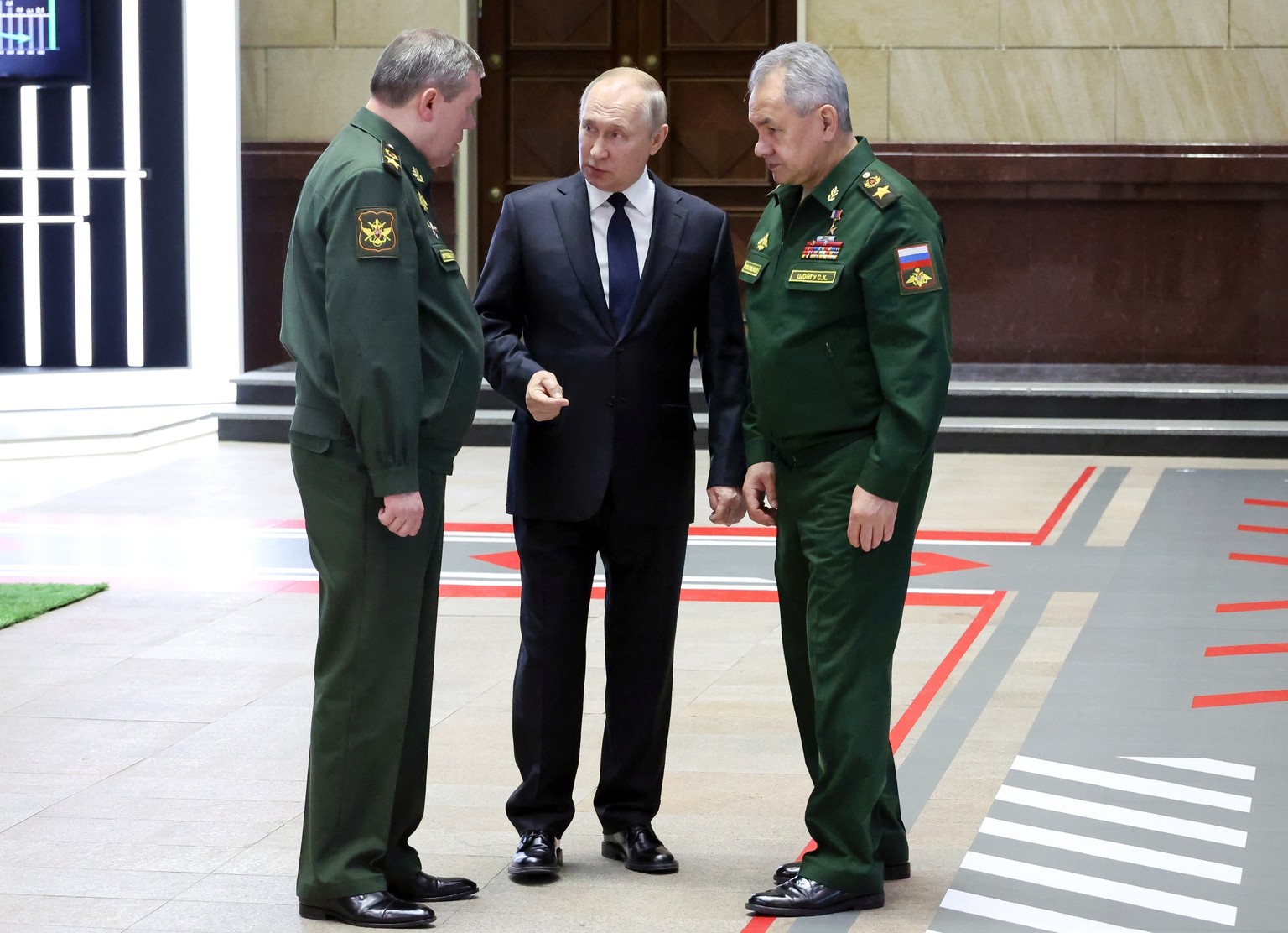 FILE - Russian President Vladimir Putin, center, speaks with Chief of the General Staff Gen. Valery Gerasimov, left, and Russian Defense Minister Sergei Shoigu, after a meeting with senior military of ...