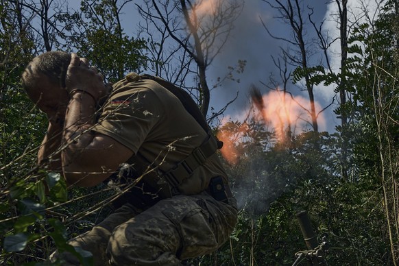 A Ukrainian soldier fires a mortar towards the Russian positions near Bakhmut, Donetsk region, Ukraine, Saturday, Sept. 2, 2023. (AP Photo/Libkos)