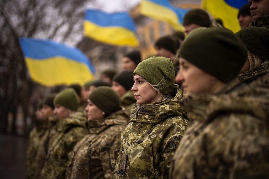 Ukrainian Army soldiers pose for a photo as they gather to celebrate a Day of Unity in Odessa, Ukraine, Wednesday, Feb. 16, 2022. (AP Photo/Emilio Morenatti)