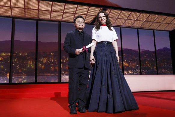CORRECTS AWARD NAME: Director Bi Gan, winner of the special award for the film &#039;Resurrection&#039;, left, poses with jury president Juliette Binoche during the awards ceremony of the 78th interna ...