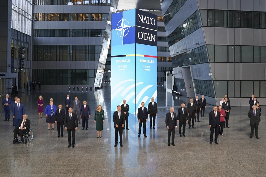 President Joe Biden and other NATO heads of the states and governments pose for a family photo during the NATO summit at the Alliance's headquarters, in Brussels, Belgium, Monday, June 14, 2021. ...