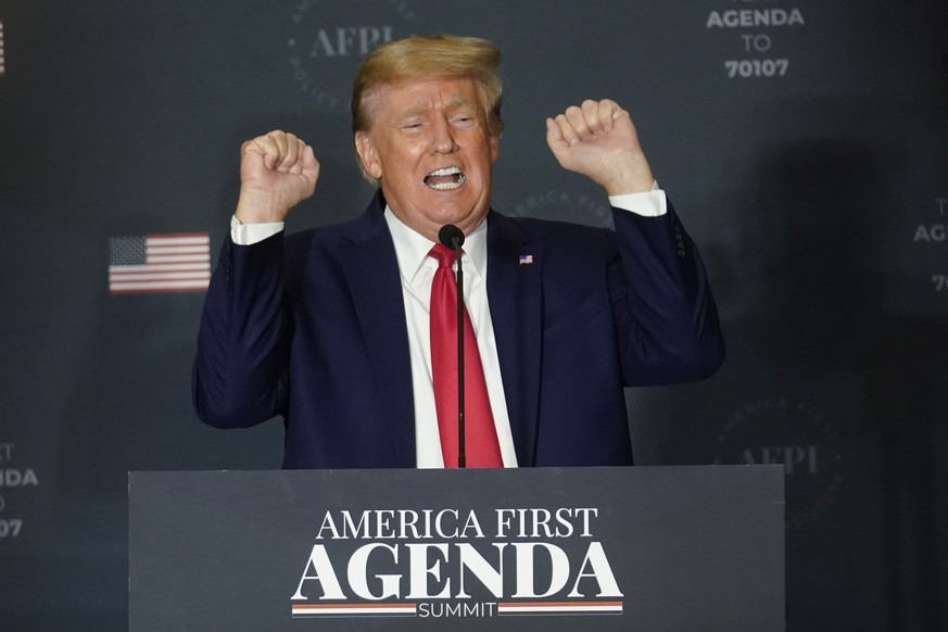 Former President Donald Trump talks about lifting weights as he speaks at an America First Policy Institute agenda summit at the Marriott Marquis in Washington, Tuesday, July 26, 2022. (AP Photo/Andre ...