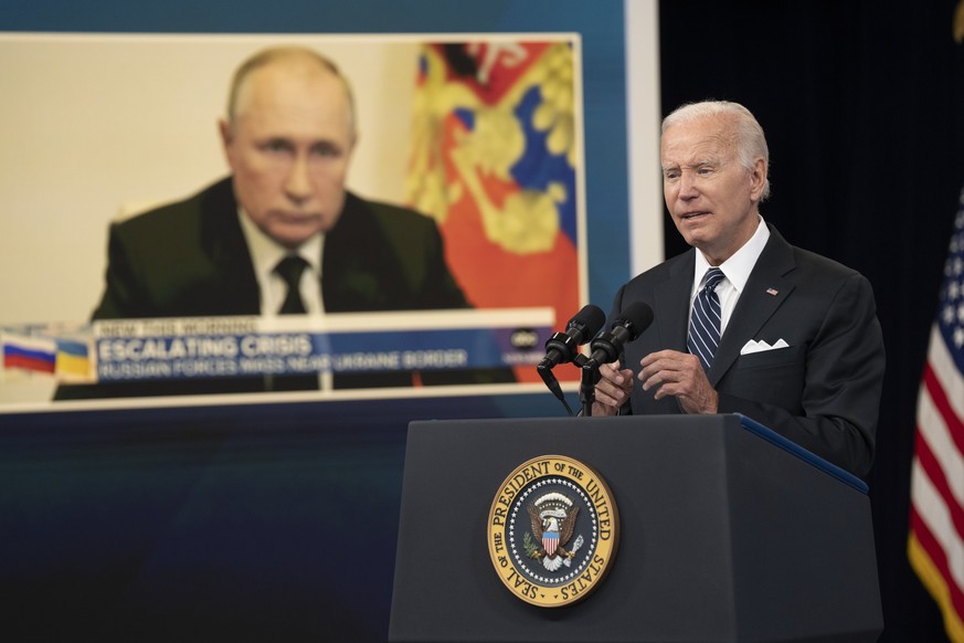 epa10028343 An image of Russian President Vladimir Putin (L) is shown as US President Joe Biden makes remarks on gas prices in the South Court Auditorium of the White House Complex in Washington, DC,  ...