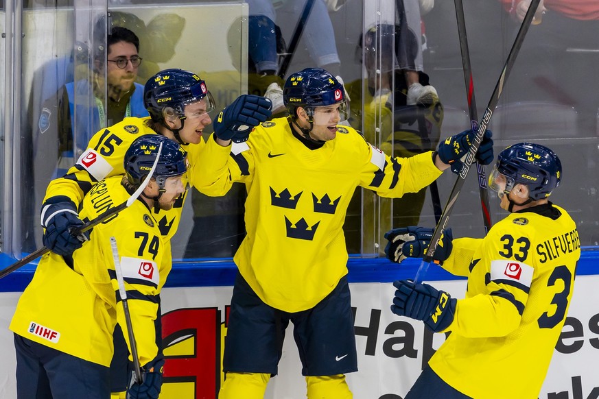 Sweden's Jacob Larsson, 2nd left, celebrates his goal with his teammates Sweden's Rasmus Asplund #74, Sweden's Jack Berglund #15 and Sweden's Jakob Silfverberg #33 aft 2:1, during  ...