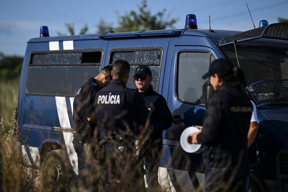 Portuguese Criminal Investigation Police (PJ) investigators stand in a road for new search operations amid the investigation into the disappearance of Madeleine (or Maddie) McCann in Lagos, in the Alg ...