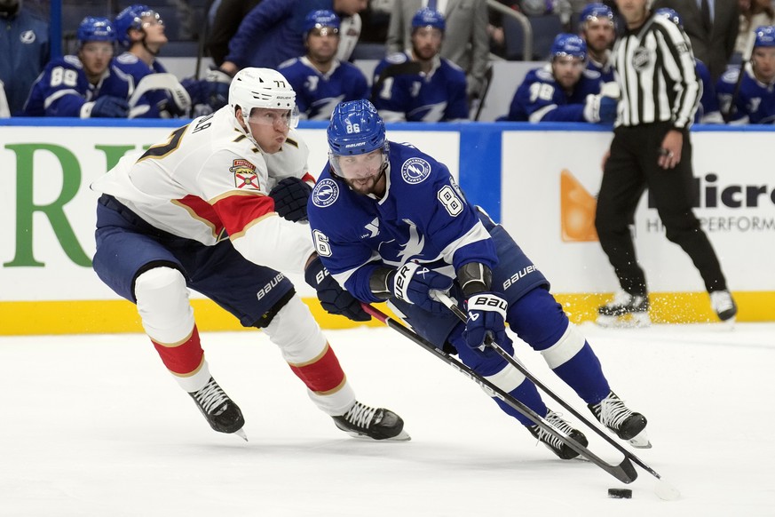 Tampa Bay Lightning right wing Nikita Kucherov (86) gets around Florida Panthers defenseman Niko Mikkola (77) during the second period of an NHL preseason hockey game Wednesday, Oct. 2, 2024, in Tampa ...