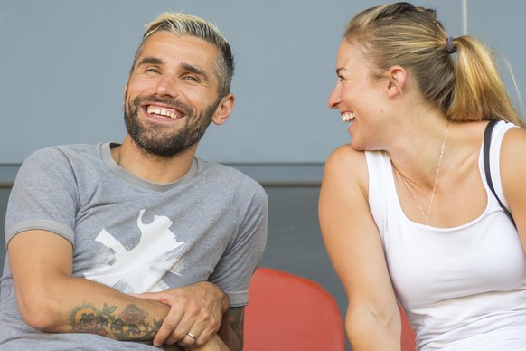 Sion&#039;s soccer player Valon Behrami, left, talks to his wife Lara Gut-Behrami, right, skier from Switzerland during a friendly soccer match between FC Sion from Switzerland and Valencia CF from Sp ...