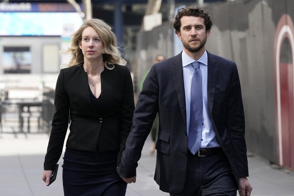 Former Theranos CEO Elizabeth Holmes, left, and her partner, Billy Evans, leave federal court in San Jose, Friday, March 17, 2023. (AP Photo/Jeff Chiu)
Elizabeth Holmes
