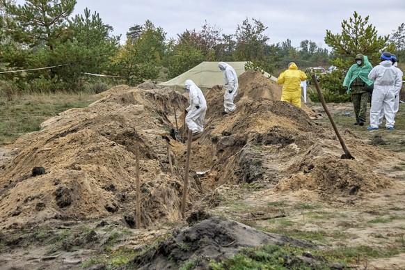 epa10237775 A picture taken during a press tour organized by the Donetsk Regional Office together with the Kharkiv Media HUB shows a mass burial site in the recently recaptured city of Lyman, Donetsk  ...