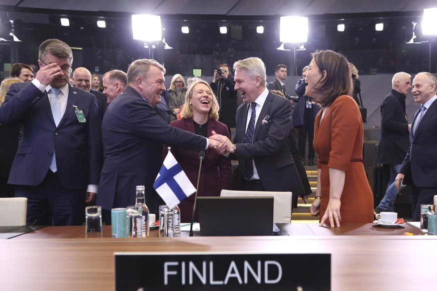 Denmark&#039;s Foreign Minister Lars Lokke Rasmussen, center left, shakes hands with Finland&#039;s Foreign Minister Pekka Haavisto as they attend the NATO-Ukraine Commission during a meeting of NATO  ...