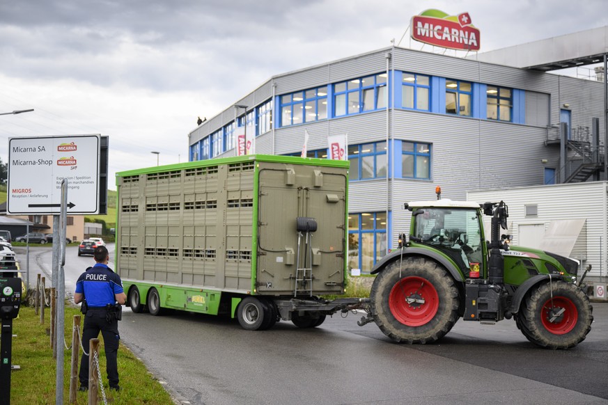 epa11449374 Police stand guard as animal rights activists of the French association &quot;269 Life Liberation Animale&quot; demonstrate on the roof of Micarna slaughterhouses in Courtepin, Switzerland ...