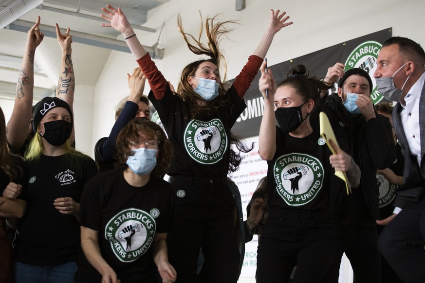 Starbucks employees and supporters react as votes are read during a viewing of their union election on Thursday, Dec. 9, 2021, in Buffalo, N.Y. Starbucks workers at a Buffalo store voted to unionize o ...