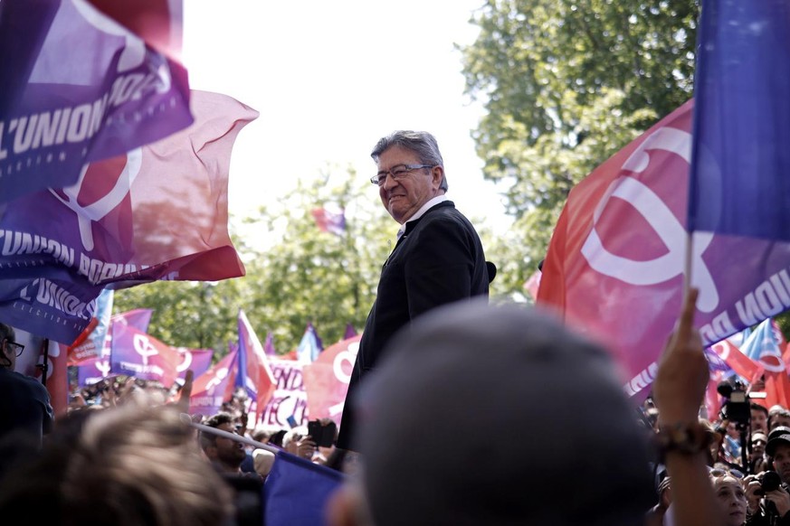 epa09920222 Far-Left party La France Insoumise (LFI) leader Jean-Luc Melenchon delivers a speech to his supporters during the annual May Day march in Paris, France, 01 May 2022. Labour Day, also known ...