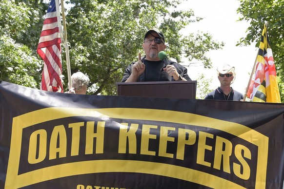 FILE - Stewart Rhodes, founder of the Oath Keepers, center, speaks during a rally outside the White House in Washington, June 25, 2017. Federal prosecutors are preparing to lay out their case against  ...