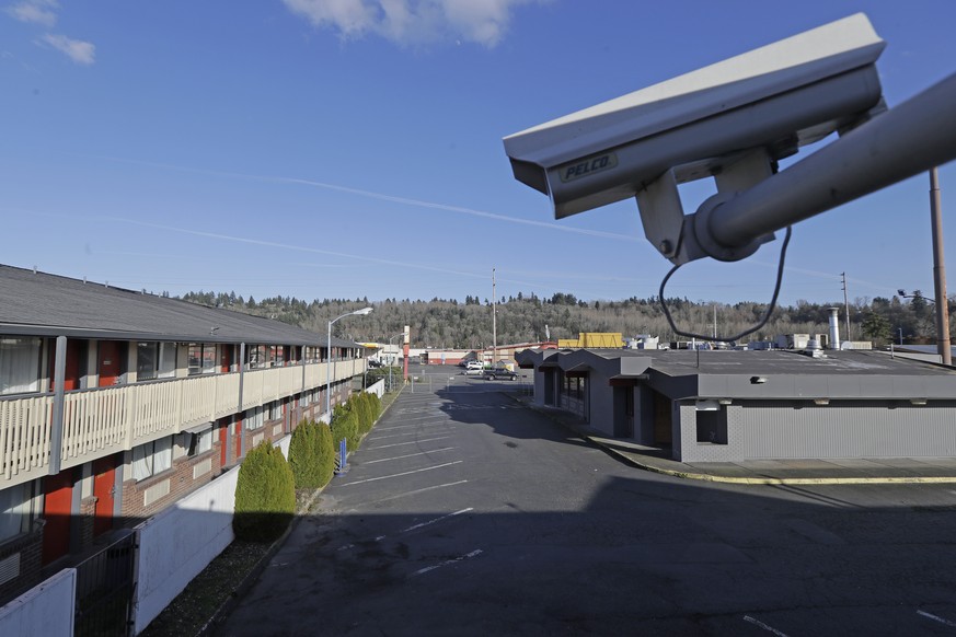 FILE - In this March 4, 2020 file photo, a security camera is shown on the second floor of a row of rooms at a motel in Kent, Wash. Hackers aiming to call attention to the dangers of mass surveillance ...