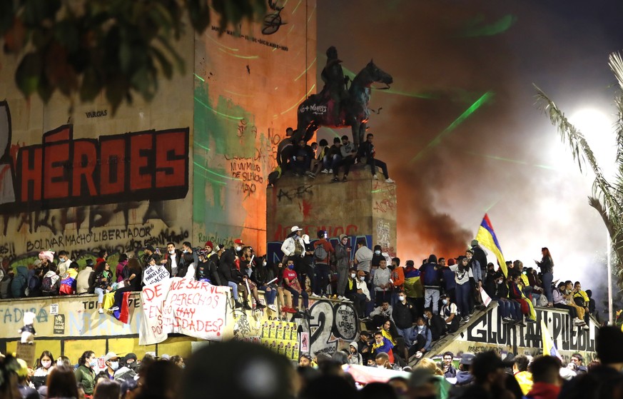 epa09203447 People gather near the Monument to the Heroes amid the ongoing National Strike protests against the Colombian government���s social and economic policies, in Bogota, Colombia, 15 May 2021. ...