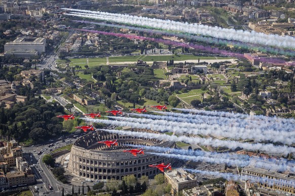 Jets from the United Kingdom&#039;s Royal Air Force Aerobatic Team, the Red Arrows, bottom, and the Italian Frecce Tricolori acrobatic squad perform a flypast over Rome to mark the state visit of Brit ...