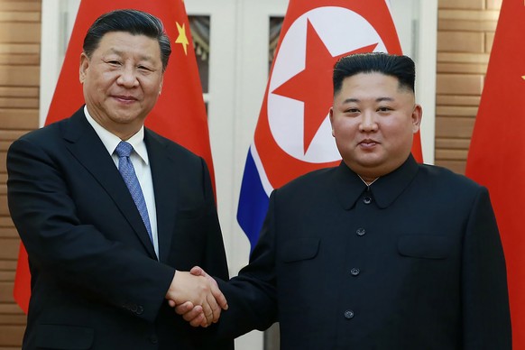 FILE - In this June 20, 2019, file photo provided by the North Korean government, North Korean leader Kim Jong Un, right, poses with Chinese President Xi Jinping for a photo at Kumsusan guest house in ...
